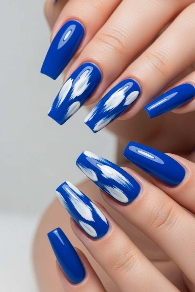 41 Long Acrylic Nail Designs for Baddies That Hit Different in 2026 16 Cobalt Blue Coffin Nails with Abstract White Brushstroke Art