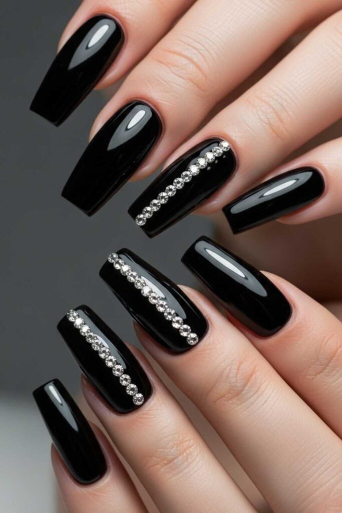 41 Long Acrylic Nail Designs for Baddies That Hit Different in 2026 8 Glossy Black Coffin Nails with Rhinestone Accent Line