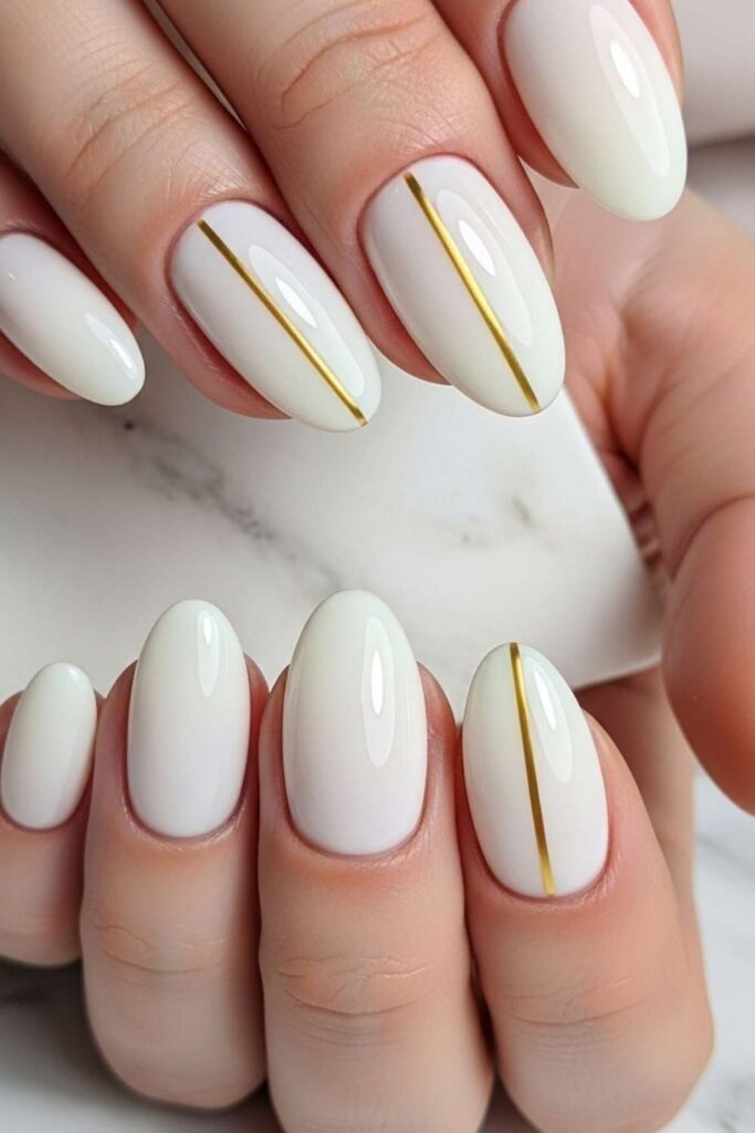 Milky White Nails with a Single Gold Accent Line