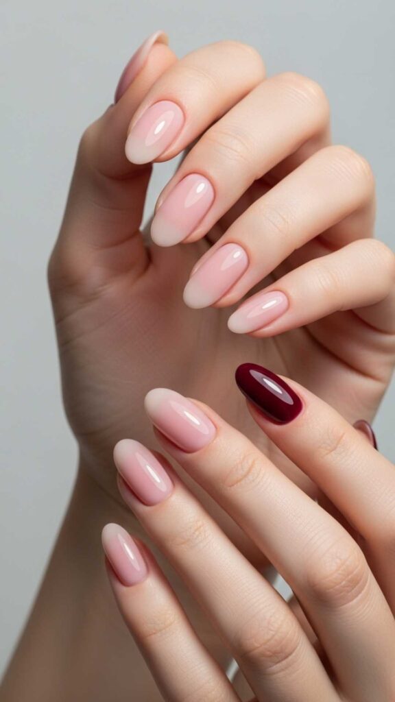 Sheer Pink Oval Nails with One Accent Nail in Burgundy