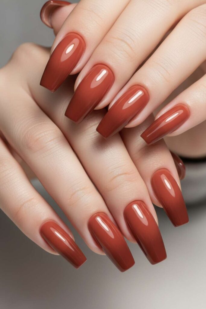 41 Long Acrylic Nail Designs for Baddies That Hit Different in 2026 14 Terracotta Coffin Nails with Rust Ombre and Gloss