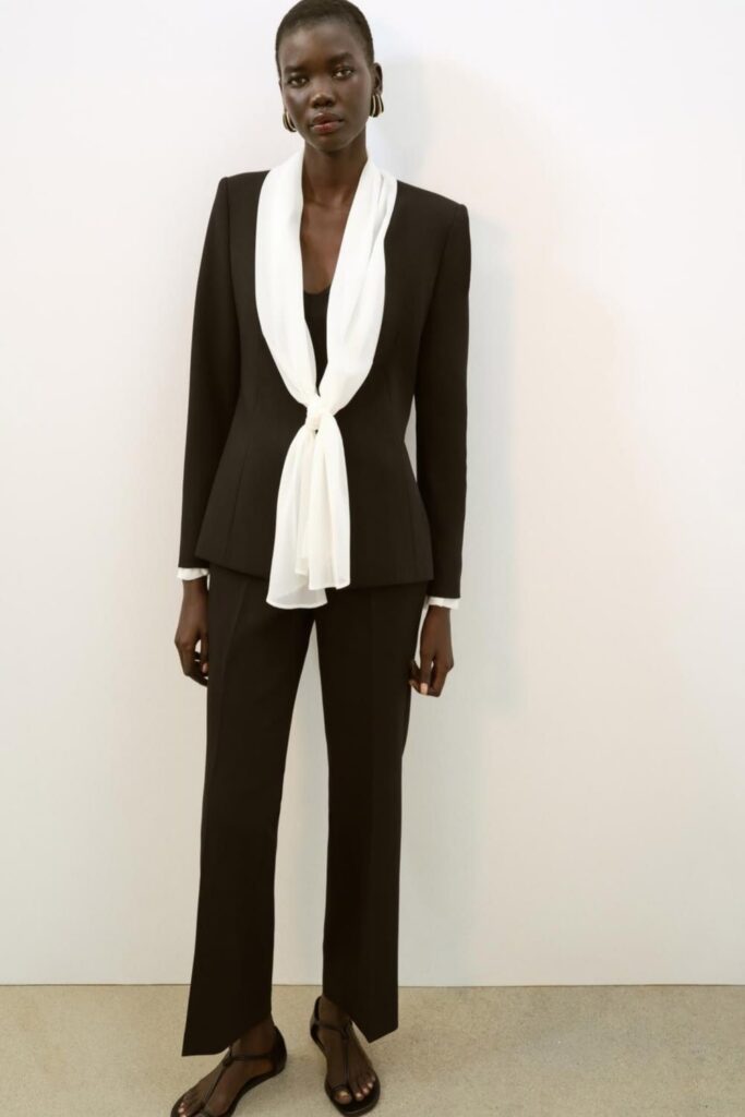 All-Black Tailored Suit with a Silk Scarf Detail