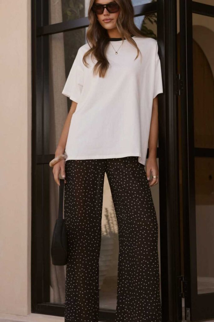 27 Color Matching Outfit Ideas That Look Effortlessly Put-Together in 2026 15 Black-and-White Printed Top with Solid Black Trousers