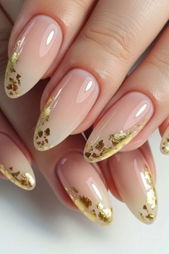 Glossy Nude Almond Nails with Gold Foil Accents