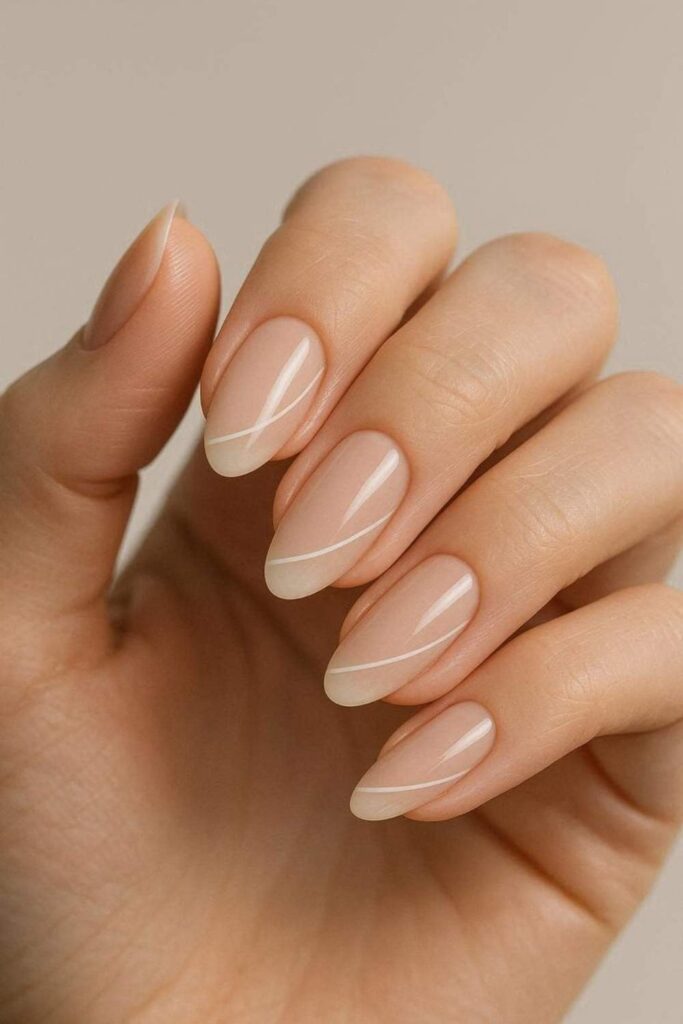 10 Simple Nail Designs for Beginners That Actually Look Expensive 2 Glossy Nude Base with a Single White Stripe