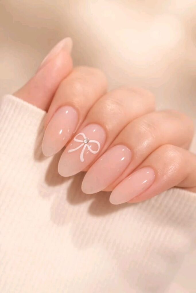 44 Cute Back to School Nails That'll Make You Actually Excited for September 11 Nude Nails with Tiny Bow Details