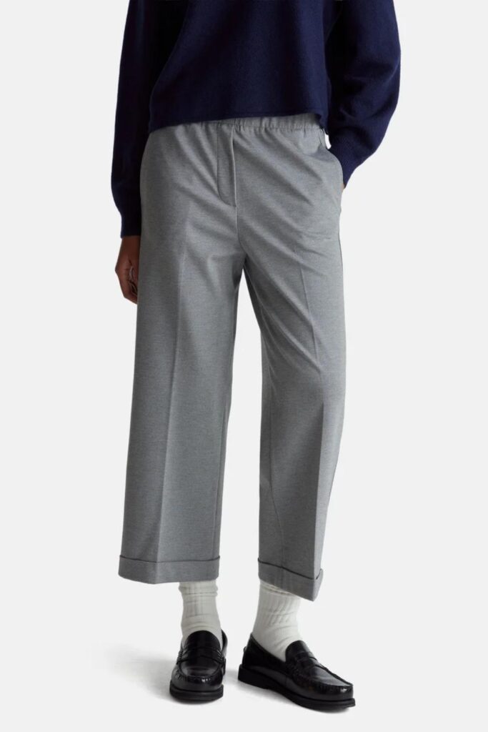 33 Stunning Office Outfits Women That Work From Desk to Dinner 14 Slate Blue V-Neck Knit with Wide-Leg Grey Trousers and Tan Loafers