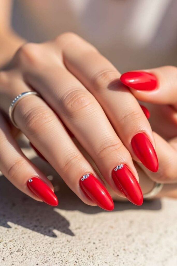 32 Red Acrylic Nail Designs That Always Look Like You Just Left the Salon 15 Solid Red Nails with a Single Crystal Accent on Each Ring Finger