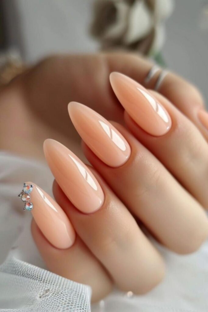 29 Summer Nail Ideas That Look Expensive Without Trying Too Hard 11 Warm Peach with a Single Pearl Accent